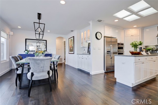 Formal Great Room/Dining Area Adjacent to Kitchen and Dry Bar with Custom China Hutch Cabinetry.