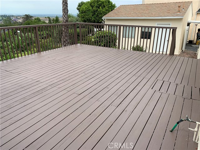 450 square foot freshly painted deck looking at garage and city view.