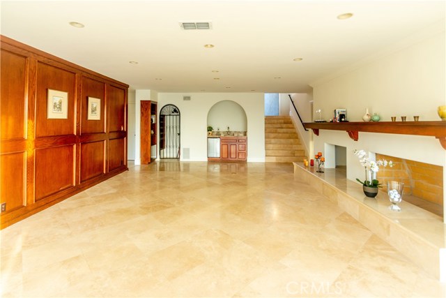 Lower level family room with fireplace and access to the pool.  There is a wet bar and wine storage closet.