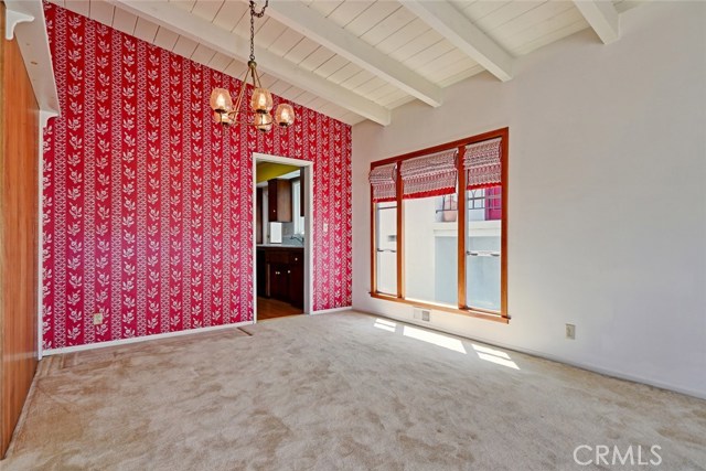 Looking from living room into dining and kitchen with west light through the windows.