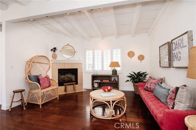 Beamed ceilings, fireplace, hardwood floors and shutters.  WOW.