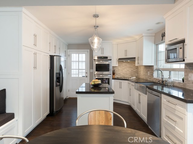 Remodeled kitchen with stainless steel appliances, farm house sink, island