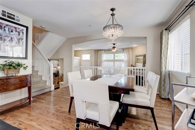 Centrally located formal dining area with hardwood floors and custom window treatment.