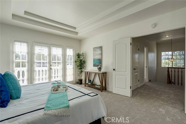 Enormous master bedroom with french doors to the left the lead out to the balcony and to the right are the double door entry.