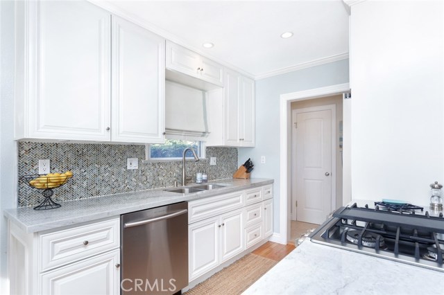 Inviting and kitchen is full of cabinets and leads to the pantry area.