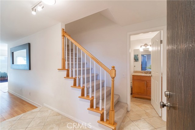 Entry Hallway leading to Bathroom on right and Living Room on Left.