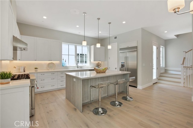 AMAZING KITCHEN WITH 2 COLORS OF QUARTZ COUNTERS & CABINTRY, BEAUTIFUL APPLIANCES,
SUBZERO FRIG, 6 BURNER STOVE & WINE CELLAR !! CUTE PATIO AREA TOO & HALF BATH.