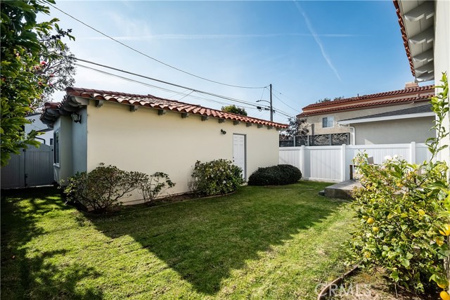 South-facing backyard with three car garage on alley