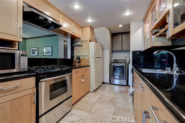 Sleek Galley Design, Glass Cabinets, Warm Wood