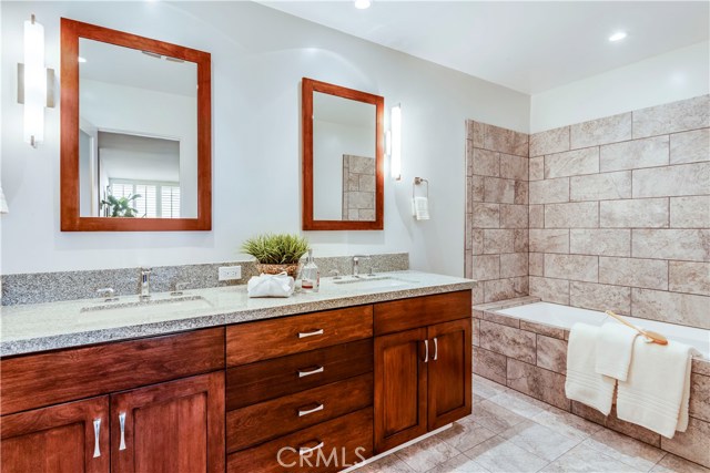 Master bath with tub, shower and two sinks.  Drawers and cabinets above behind door a plus.