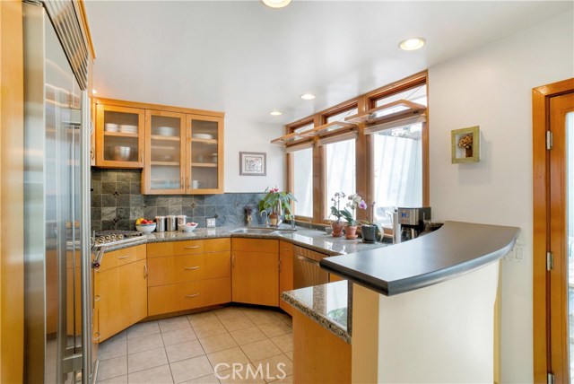 Efficient kitchen where everything is within reach.  Newer stainless steel appliances include a 36¨ Sub Zero refrigerator, convection oven, cooktop and dishwasher.