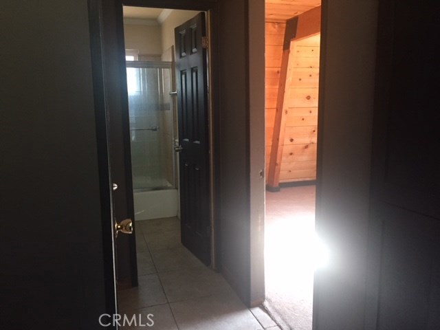 Hallway leads to downstairs bath straight ahead. To the left is the laundrycloset and hot water heater closet. To the right is the downstairs bedroom.