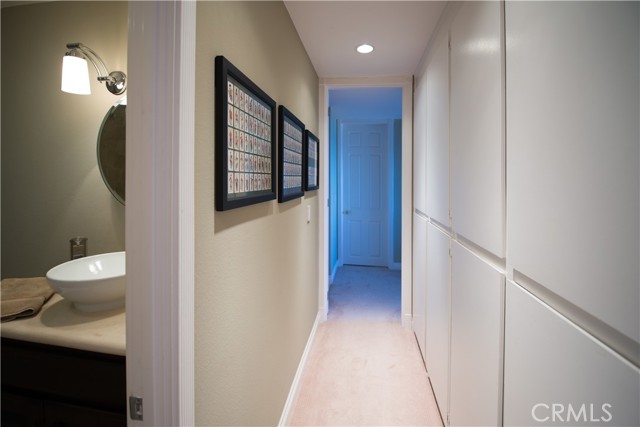 Bedroom hallway with linen closets and guest bath appearing on the left