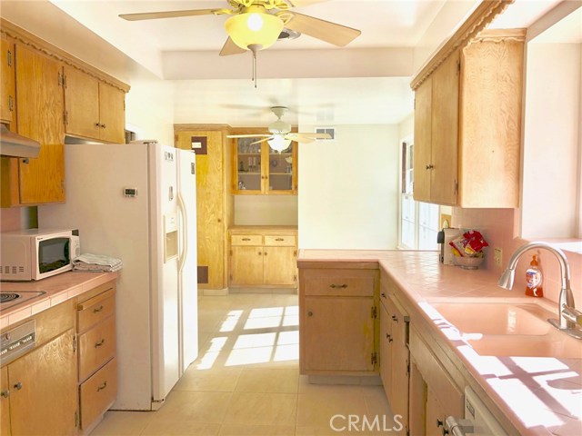 Kitchen Has Charming Cabinetry and Newer Tile Flooring. Freshly Painted as Well.