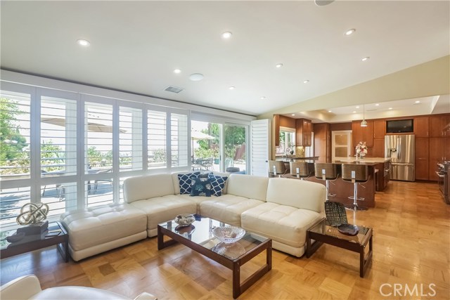 Living room, wall of dual paned windows with plantation shutters, open floor plan.  Perfect for entertaining while taking in the views!