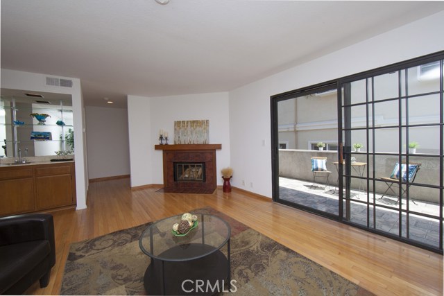 Living room with hardwood floors, fireplace and wet bar.