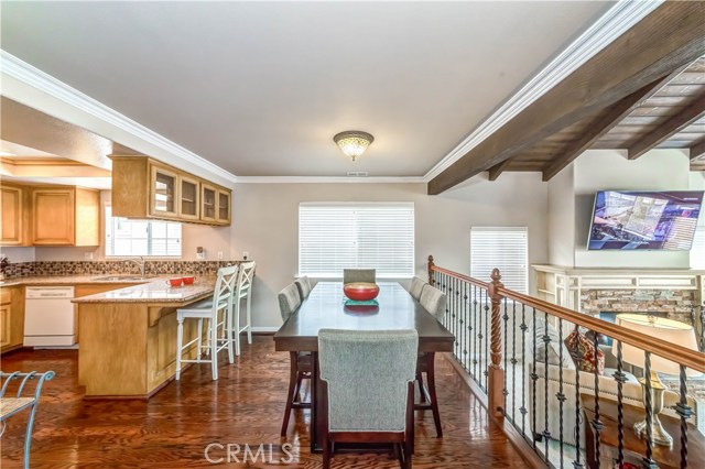 Dining area w/wrought iron railing Not impacting the beautiful kitchen flooring making cleaning quick and easy.  Living room area off to the right of image