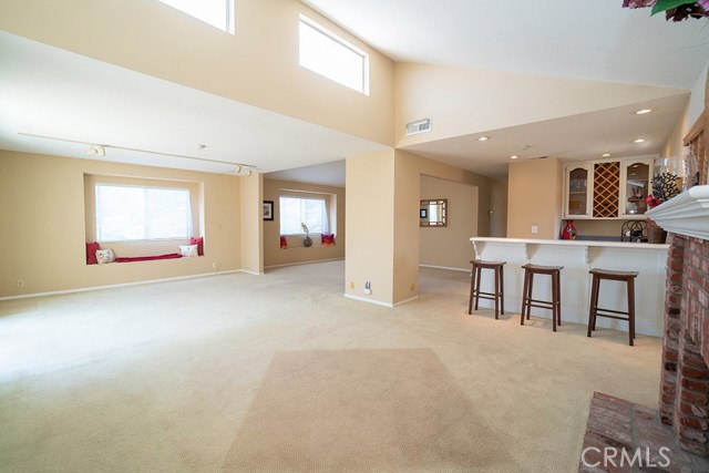 Formal Living Room with Brick Fire place looking towards Wet Bar