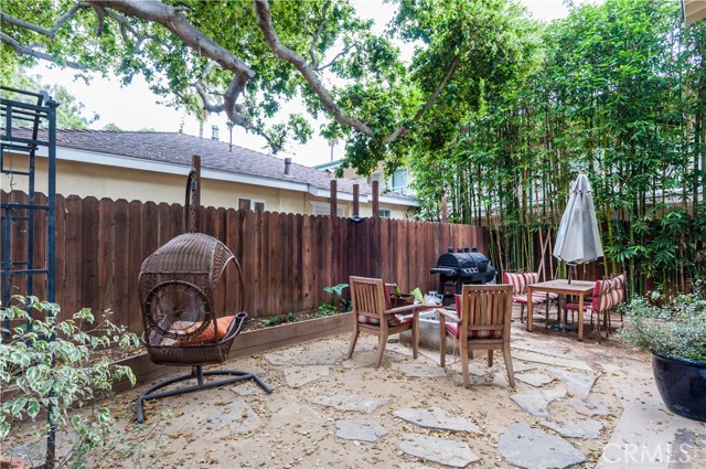 Main house has a very nice stone paver patio with giant shade tree, bamboo, gas firepit and privacy!