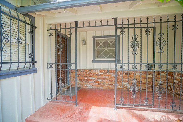 The front porch entry, protected by a locked gate.