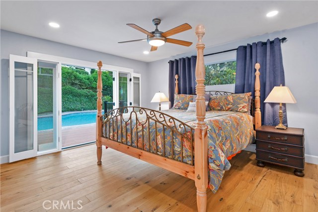 The master bedroom that leads out to a timber-tech deck through French doors that overlooks the private pool.