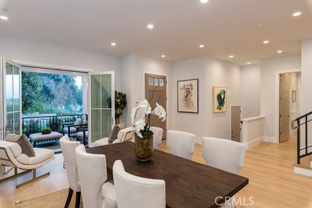 Expansive, entrance room (shown here as a dining space) graciously opens to front patio.
