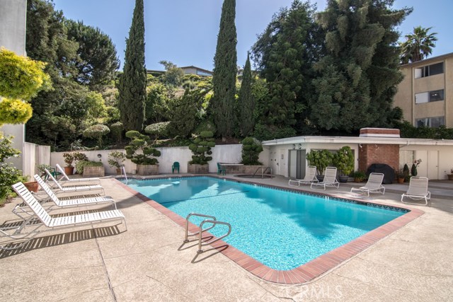 Heated pool and spa and view of rec room.