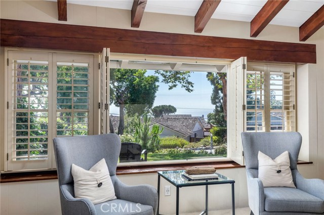 The ocean view living room brings gorgeous golden sunsets in a picturesque setting. The quintessential charm of a Palos Verdes Estates Ranch home can be found in the detail of this custom built home.