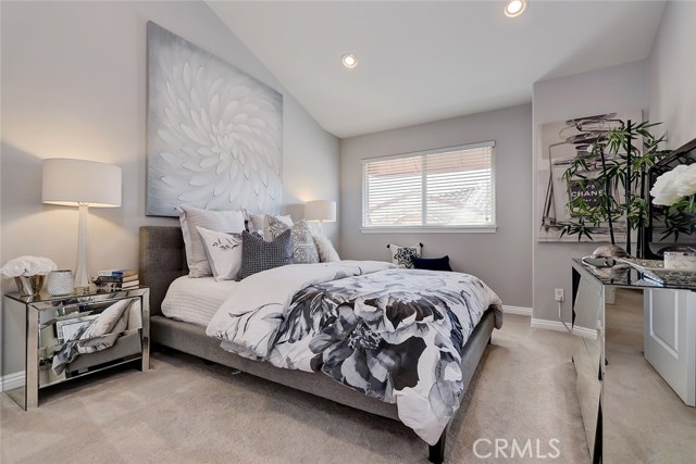 Light, bright and serene 2nd bedroom with vaulted ceilings, custom window treatments and baseboards.