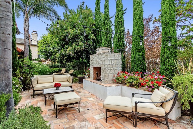 Daylight view of the back patio w/custom fireplace.