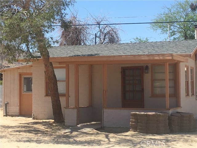 casita with covered porch. Utility room with washer and dryer on left