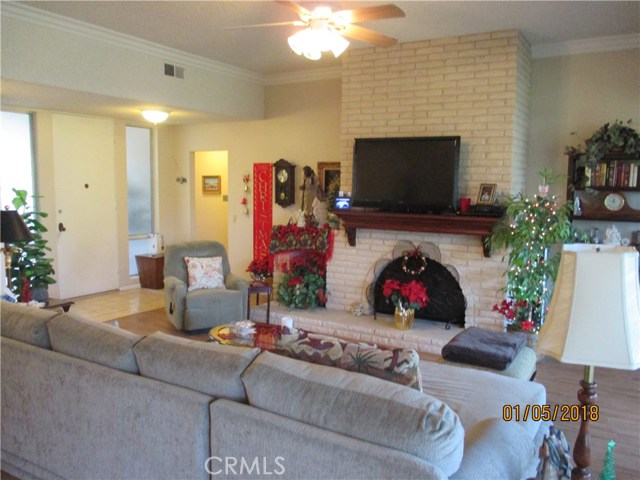 Large fireplace with wood storage section and television for comfortable evenings.