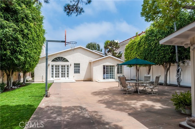 Parklike backyard has lighted sports court, mature shade trees and large Ficus trees that provide privacy from homes on both sides.