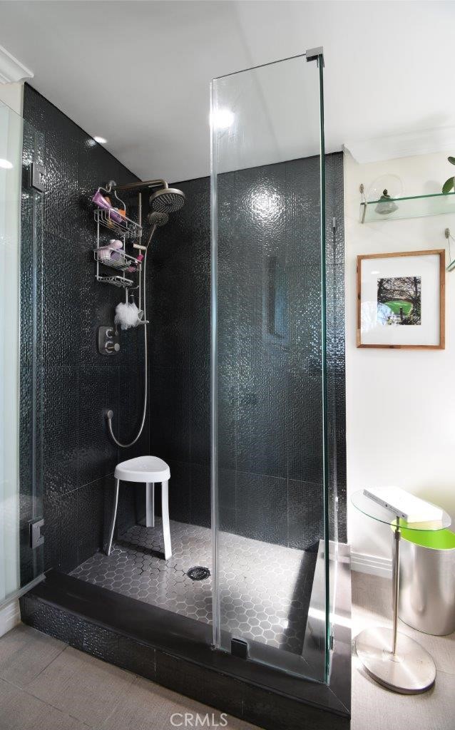 beautiful mosaic tiles in this multifunctional shower