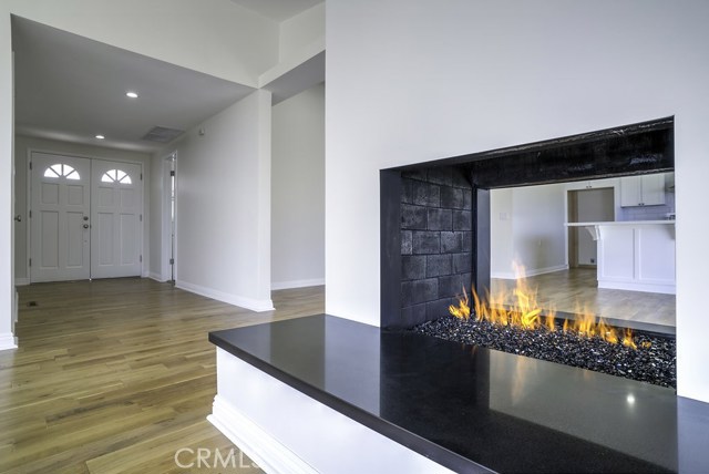 Entry to the left. Fireplace with Starfire Glass and quartz sitting bench.