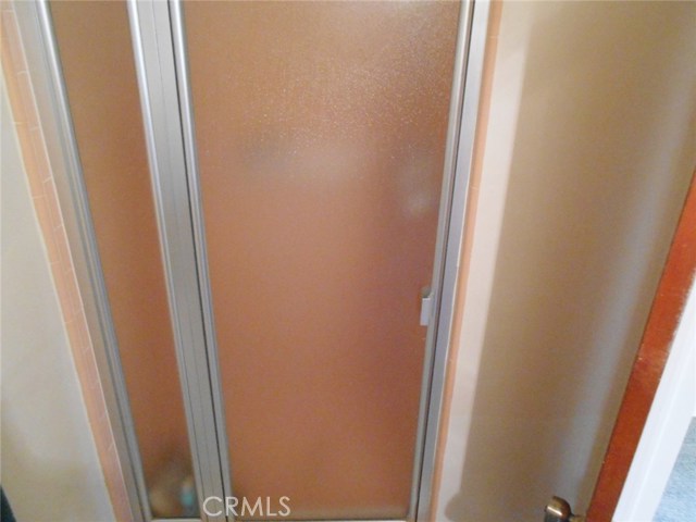Stand -Up Shower in Bathroom, Tiled and Very Clean.