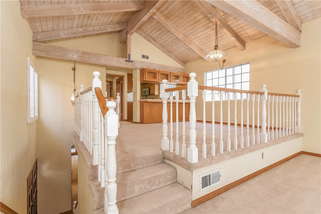 The dining room is surrounded by a nice wooden railing giving a sense of quality and openness while still seperating the dining area