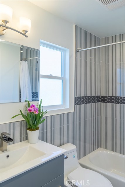 A water fall faucet and designer tile are showcased in the 2nd bathroom.