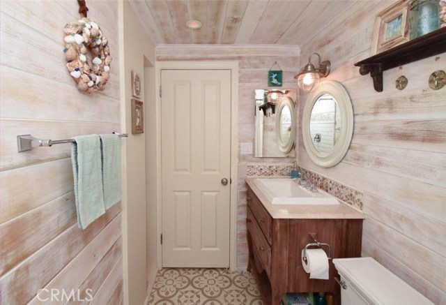 Custom vanity, marble counter top, Granada tile floors & whitewashed shiplap in this 3/4 Bath.