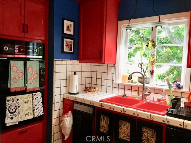 Kitchen tile counter and french window to front yard.