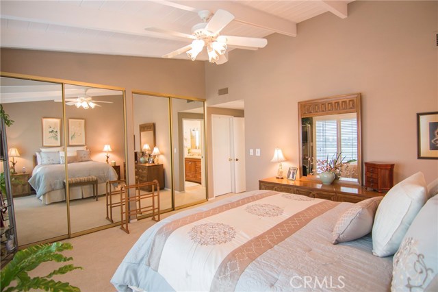 Elegant master bedroom looking towards full-wall wardrobes & en-suite