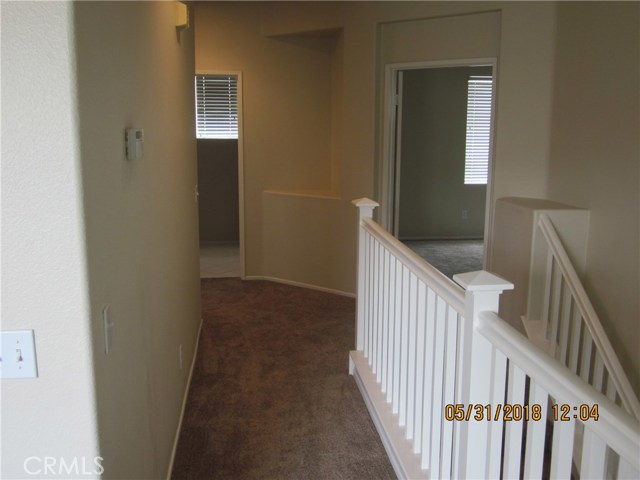 View to laundry room and master bedroom from upstairs hall.