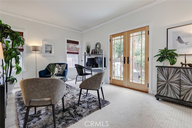 Bright guest bedroom with french doors leading to the backyard oasis.