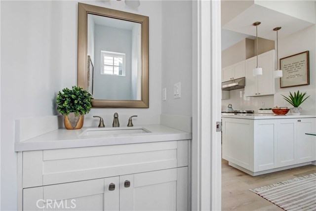 CONVENIENT HALF BATH IN BACK OF KITCHEN