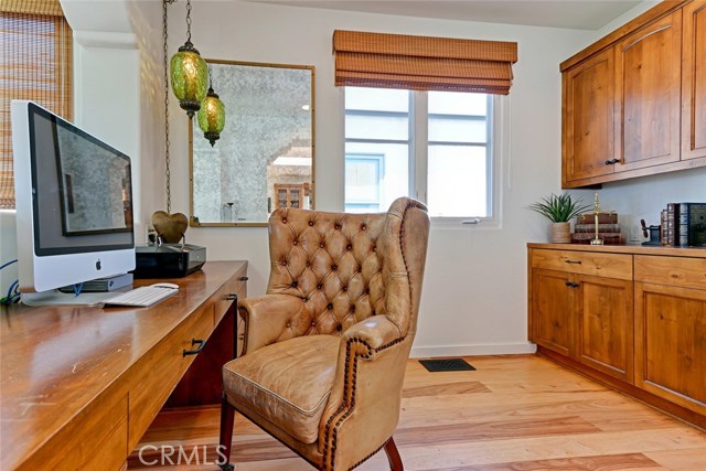 Office comes  with custom built-in wood cabinetry and plenty of storage.