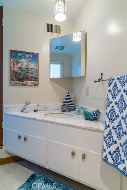 Downstairs bath includes large closet.  Original seahorse light fixture.