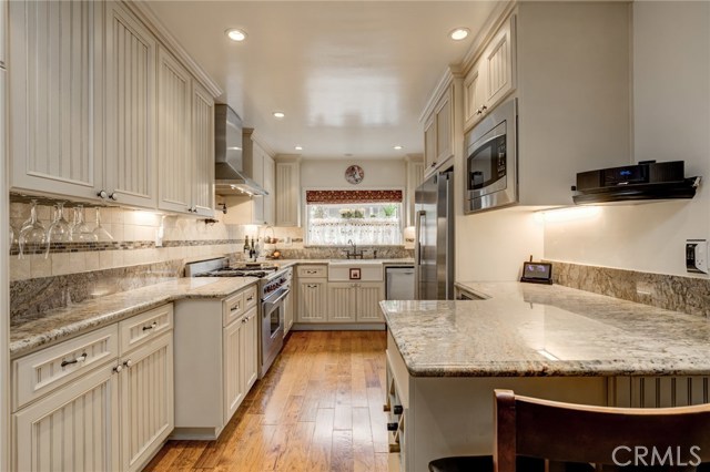 Kitchen has custom cabinetry and granite countertops