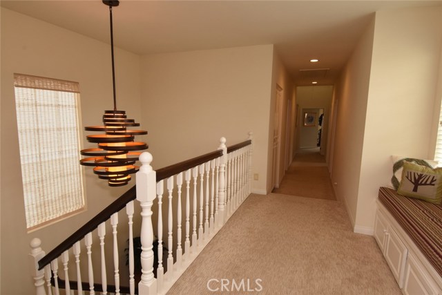 Upstairs landing looking toward 3 of the 4 bedrooms.  Pretty built in bench seat with storage below on the right.
