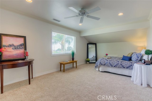 The room itself is big enough for a separate sitting area and includes new, mirrored wardrobe closet doors for him and a walk in closet for her.