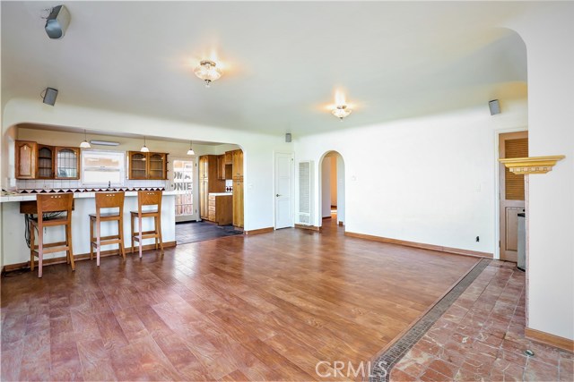 The living room is open to the Kitchen and is a great entertaining area with a coving, a fireplace and ocean view decks.